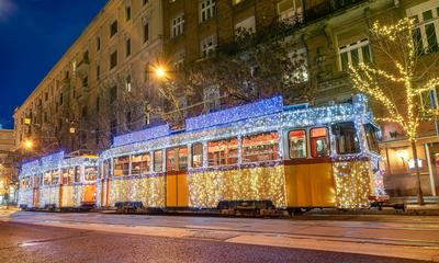 Festively decorated light tram (fenyvillamos) by night. Christmas season in Budapest . Vintage tram from Budapest city decorated with Christmas lights-stock-photo