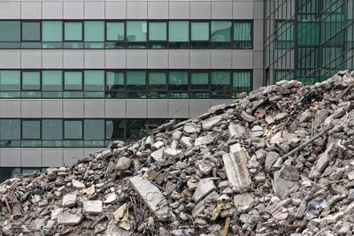 House demolition debris next to modern buildings.-stock-foto