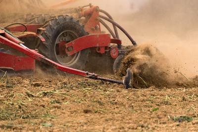 A farmer working on the field with a Horsch Pronto 4dc seeding drill.-stock-photo