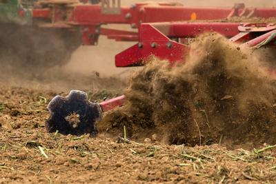 A farmer working on the field with a Horsch Pronto 4dc seeding drill.-stock-photo
