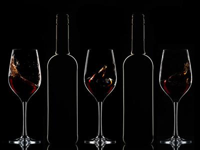 Red wine bottles and filled glasses-stock-photo