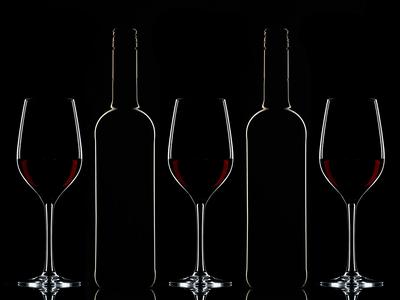 Red wine bottles and filled glasses-stock-photo
