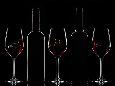 Red wine bottles and filled glasses-stock-photo