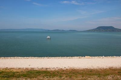 Landscape by lake Balaton with white bench in the water.-stock-photo