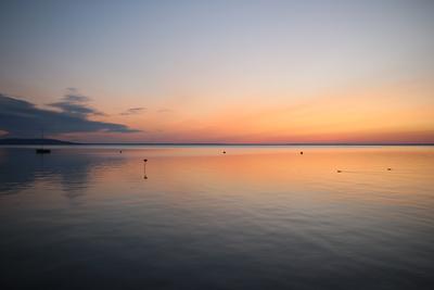 Sunrise at lake with sailboat-stock-foto
