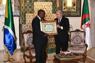 Algerian President Abdelmadjid Tebboune honors South African President Cyril Ramaphosa, and awards him the Athir Medal,-stock-photo