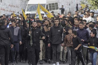 Mourners carry the body of Palestinian Jehad Abu Salim who was killed in an Israeli raid, during his funeral in Balata camp in Nablus-stock-photo