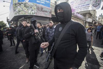 Mourners carry the body of Palestinian Jehad Abu Salim who was killed in an Israeli raid, during his funeral in Balata camp in Nablus-stock-photo