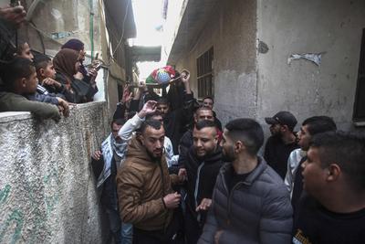 Mourners carry the body of Palestinian Jehad Abu Salim who was killed in an Israeli raid, during his funeral in Balata camp in Nablus-stock-photo