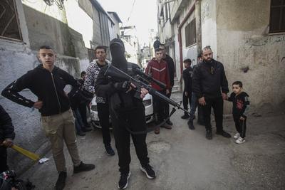 Mourners carry the body of Palestinian Jehad Abu Salim who was killed in an Israeli raid, during his funeral in Balata camp in Nablus-stock-photo