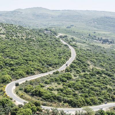 Road on the Golan Heights in Israel. Winding Asphalt road on the Golan Heights in Israel. Scenery on the slopes of mount-stock-foto