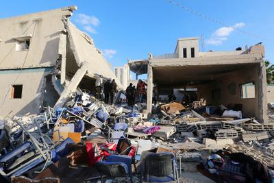 Palestinian residents and civil defense teams conduct a search and rescue operation in the Deir al-Balah-stock-photo