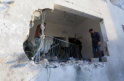 Palestinian residents and civil defense teams conduct a search and rescue operation in the Deir al-Balah-stock-photo
