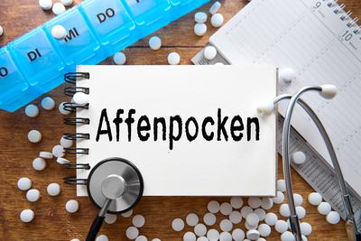 13 August 2024: Diagnosis: monkeypox, surrounded by pills and medical equipment. PHOTOMONTAGE *** Diagnose: Affenpocken,-stock-foto