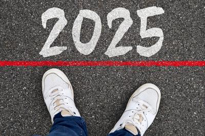 4 November 2024: With the year 2025 at his feet, a man stands symbolically on the threshold of the future. The red line-stock-photo