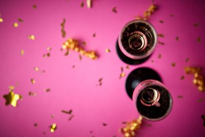 Two glasses full of sparkling champagne wine with golden decoration Two glasses full of sparkling champagne wine with go-stock-photo