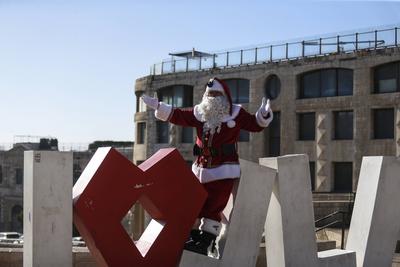 Christmas preparations in Jerusalem JERUSALEM - DECEMBER 19: Christian Palestinian Issa Kassissieh, dressed as Santa Cla-stock-photo