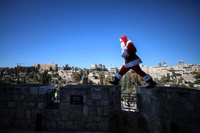 Christmas preparations in Jerusalem JERUSALEM - DECEMBER 19: Christian Palestinian Issa Kassissieh, dressed as Santa Cla-stock-photo