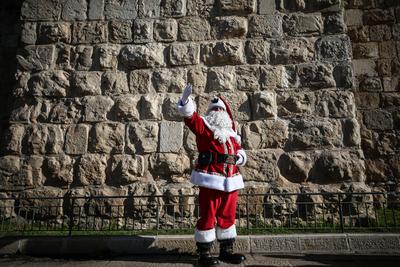 Christmas preparations in Jerusalem JERUSALEM - DECEMBER 19: Christian Palestinian Issa Kassissieh, dressed as Santa Cla-stock-photo