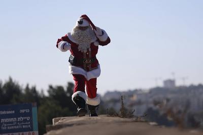 Christmas preparations in Jerusalem JERUSALEM - DECEMBER 19: Christian Palestinian Issa Kassissieh, dressed as Santa Cla-stock-photo
