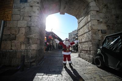 Christmas preparations in Jerusalem JERUSALEM - DECEMBER 19: Christian Palestinian Issa Kassissieh, dressed as Santa Cla-stock-photo