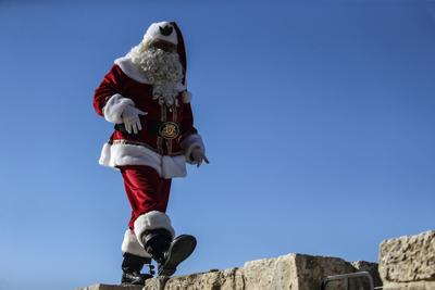 Christmas preparations in Jerusalem JERUSALEM - DECEMBER 19: Christian Palestinian Issa Kassissieh, dressed as Santa Cla-stock-photo