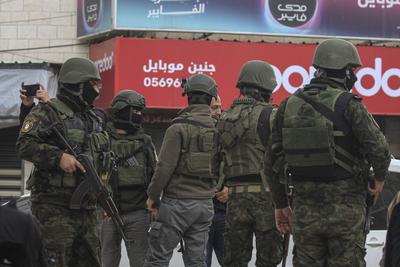 Palestinian security forces gather at the site of a protest against clashes between Palestinian security forces and militants in the northern occupied West Bank city of Jenin-stock-photo