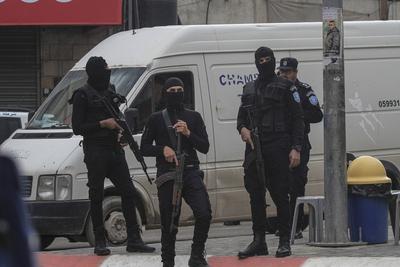 Palestinian security forces gather at the site of a protest against clashes between Palestinian security forces and militants in the northern occupied West Bank city of Jenin-stock-photo