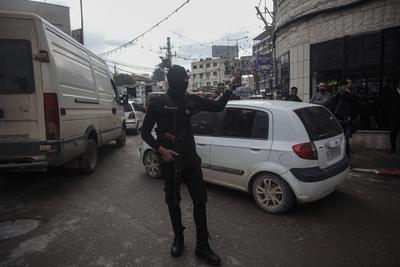 Palestinian security forces gather at the site of a protest against clashes between Palestinian security forces and militants in the northern occupied West Bank city of Jenin-stock-photo
