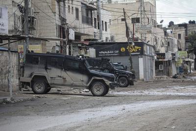 Palestinian security forces gather at the site of a protest against clashes between Palestinian security forces and militants in the northern occupied West Bank city of Jenin-stock-photo