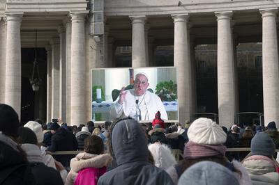 ITALY -  PEOPLE HOLD STATUETTES OF BABY JESUS IN ST PETER'S SQUARE AT  THE VATICAN  - 2024/12/22-stock-photo