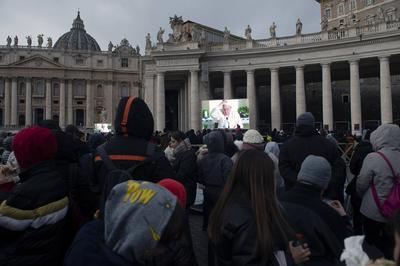 ITALY -  PEOPLE HOLD STATUETTES OF BABY JESUS IN ST PETER'S SQUARE AT  THE VATICAN  - 2024/12/22-stock-photo