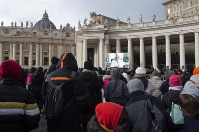 ITALY -  PEOPLE HOLD STATUETTES OF BABY JESUS IN ST PETER'S SQUARE AT  THE VATICAN  - 2024/12/22-stock-photo