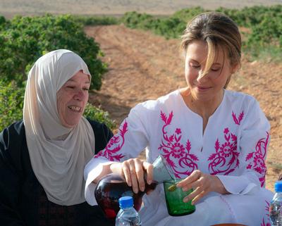 Syrian First Lady Asma al-Assad attends the harvest of Damascena (Damask) roses in the village of al-Marah, in the Damas-stock-photo