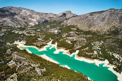 Aerial shot of Guadalest Reservoir and surrounded mountains-stock-photo