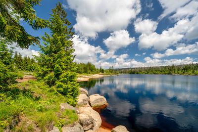 A view of the Oderteich pond in the Harz Mountains in Germany A view of the Oderteich in the Harz Mountains under a blue-stock-photo