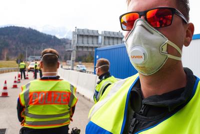 Border controls in F?ssen, March 17, 2020. Policemen control every vehicle entering the border to Germany due to the Co-stock-photo