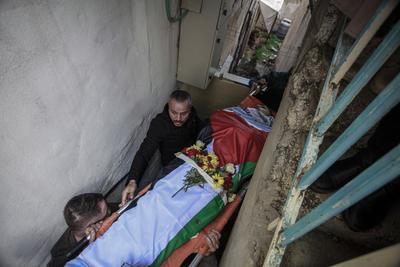Palestinians carry the body of Moataz al-Madani, 16, who was killed during clashes with Israeli occupation forces, in Askar camp east of the West Bank city of Nablus-stock-photo