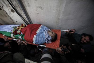 Palestinians carry the body of Moataz al-Madani, 16, who was killed during clashes with Israeli occupation forces, in Askar camp east of the West Bank city of Nablus-stock-photo