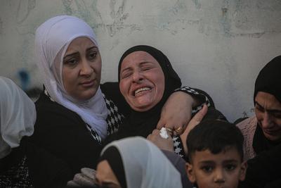 Palestinians carry the body of Moataz al-Madani, 16, who was killed during clashes with Israeli occupation forces, in Askar camp east of the West Bank city of Nablus-stock-photo