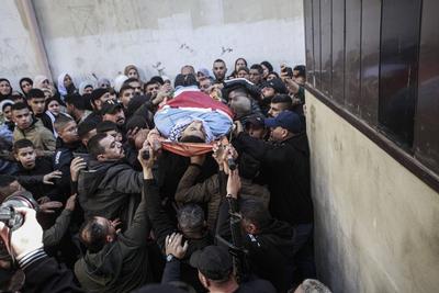 Palestinians carry the body of Moataz al-Madani, 16, who was killed during clashes with Israeli occupation forces, in Askar camp east of the West Bank city of Nablus-stock-photo