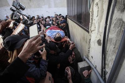 Palestinians carry the body of Moataz al-Madani, 16, who was killed during clashes with Israeli occupation forces, in Askar camp east of the West Bank city of Nablus-stock-photo