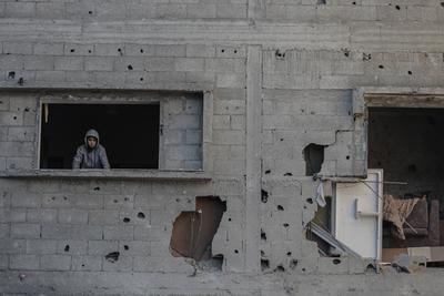 Palestinians check the site of a destroyed house after an Israeli bombardment, in the Al-Bureij refugee camp in central Gaza Strip-stock-photo