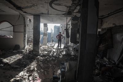 Palestinians inspect the damage after an Israeli air strike on an apartment in Deir al-Balah, central Gaza Strip-stock-photo