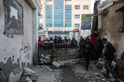 Palestinians inspect the damage after an Israeli air strike on an apartment in Deir al-Balah, central Gaza Strip-stock-photo