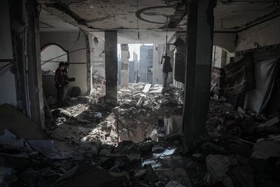 Palestinians inspect the damage after an Israeli air strike on an apartment in Deir al-Balah, central Gaza Strip-stock-photo