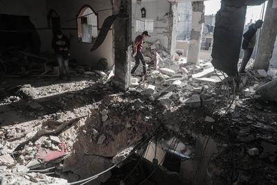 Palestinians inspect the damage after an Israeli air strike on an apartment in Deir al-Balah, central Gaza Strip-stock-photo