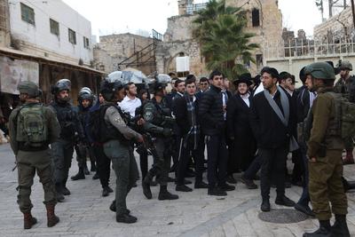 Israeli settlers escorted by Israeli forces participate in a provocative tour in Hebron-stock-foto