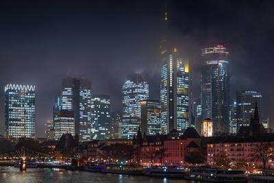 Die Frankfurter Skyline am Abend Tiefe Wolken umh?llen die leuchtenden T?rme der Frankfurter Bankenskyline am Abend. Fra-stock-foto