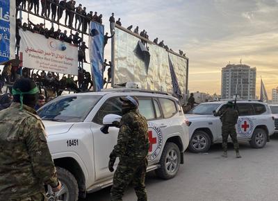 Palestinians gather near the site of the handover of the Israeli hostages to the International Committee of the Red Cross (ICRC)-stock-photo